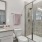 glassed, walk-in shower in well lit bathroom