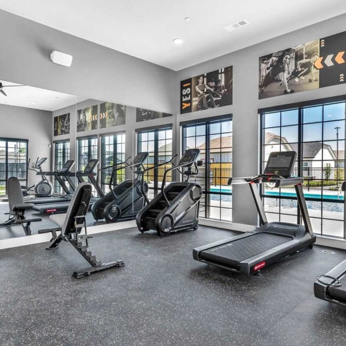 spacious fitness center with pool views