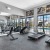 spacious fitness center with pool views