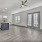 spacious living room with ceiling fan and light